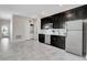 Bright kitchen with black cabinetry, stainless appliances and a conveniently-located laundry closet at 11357 Satire St, Orlando, FL 32832