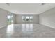 Spacious living room with large windows and sliding glass doors, and tile flooring at 11357 Satire St, Orlando, FL 32832