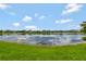 Scenic view of the pond with blue skies and clouds reflected in the water at 11357 Satire St, Orlando, FL 32832