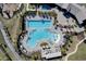 Aerial view of a luxurious community pool with ample seating and lush landscaping at 11357 Satire St, Orlando, FL 32832
