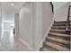Carpeted staircase featuring wood handrail with a view into the spacious hallway at 11357 Satire St, Orlando, FL 32832