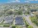Aerial view of a neighborhood featuring mature trees, a fenced-in backyard, and a screened pool at 3136 Heartleaf Pl, Winter Park, FL 32792