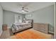 Bedroom with a cozy bed, dresser, ceiling fan, and a bright orange rug at 3136 Heartleaf Pl, Winter Park, FL 32792