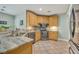 Kitchen with stainless steel appliances, tiled floor, and light wood cabinetry at 3136 Heartleaf Pl, Winter Park, FL 32792