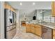 Bright kitchen with stainless steel appliances, tiled floor, and an open view to living room at 3136 Heartleaf Pl, Winter Park, FL 32792