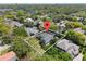 Aerial view of the property showcasing its prime location, landscaped yard, and proximity to surrounding neighborhoods at 8704 Crestgate Cir, Orlando, FL 32819
