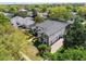 Aerial view of the property with lush landscaping and a beautiful gray tile roof at 8704 Crestgate Cir, Orlando, FL 32819