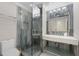 An updated bathroom with a custom vanity, modern lights, and glass shower at 8704 Crestgate Cir, Orlando, FL 32819