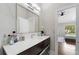 Modern bathroom with a large mirror, stylish vanity, and sleek lighting fixtures at 8704 Crestgate Cir, Orlando, FL 32819