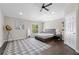 Bright bedroom featuring a large window, modern ceiling fan, and stylish decor at 8704 Crestgate Cir, Orlando, FL 32819