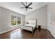 A bright bedroom with hardwood floors and a large window at 8704 Crestgate Cir, Orlando, FL 32819