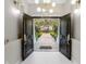 Grand entryway featuring double doors, a modern chandelier, and a view of the beautifully landscaped front yard at 8704 Crestgate Cir, Orlando, FL 32819