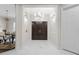 Elegant entryway with marble floors, stylish lighting, and an open view to the dining area at 8704 Crestgate Cir, Orlando, FL 32819
