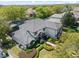 Beautiful two-story home boasts a gray tile roof, manicured landscaping, and a welcoming entrance at 8704 Crestgate Cir, Orlando, FL 32819