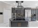 Elegant kitchen featuring an island cooktop, stainless steel appliances, and ample cabinet space at 8704 Crestgate Cir, Orlando, FL 32819
