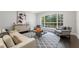 Bright living room features a large window, neutral furniture, and stylish decor at 8704 Crestgate Cir, Orlando, FL 32819