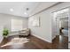 Bright loft area features hardwood floors, a comfortable chair, and a window with natural light at 8704 Crestgate Cir, Orlando, FL 32819