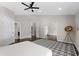 Spacious main bedroom features a ceiling fan, ensuite bathroom, and large doorway leading to additional living space at 8704 Crestgate Cir, Orlando, FL 32819