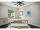 A bright office with hardwood floors, a large window and neutral colors at 8704 Crestgate Cir, Orlando, FL 32819