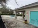 Community pool area with covered seating, a blue door and lush landscaping at 3612 Julius Estates Blvd, Winter Haven, FL 33881