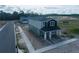 Two-story home under construction with gray and black color scheme, front porch, and landscaped yard at 5274 Teirgarten St, Saint Cloud, FL 34771