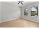 Well-lit bedroom featuring two large windows, ceiling fan and beautiful hardwood flooring at 1904 Illinois St, Orlando, FL 32803