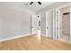 Bright bedroom featuring hardwood floors, light gray walls, and access to an en-suite bathroom and additional bedroom at 1904 Illinois St, Orlando, FL 32803