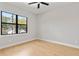 Bedroom with a large window offering great outdoor views, neutral walls, and hardwood floors at 1904 Illinois St, Orlando, FL 32803