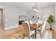 Open dining area with hardwood floors, a modern chandelier, and plenty of natural light at 1904 Illinois St, Orlando, FL 32803