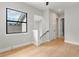Bright hallway features a stairwell with modern railings, doors leading to various rooms, and natural light at 1904 Illinois St, Orlando, FL 32803