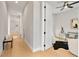 Bright hallway with light wood floors leads to a well-lit room with modern decor at 1904 Illinois St, Orlando, FL 32803