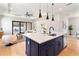 Stylish kitchen featuring a navy blue island with quartz countertop and pendant lighting at 1904 Illinois St, Orlando, FL 32803