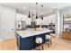 Modern kitchen with white cabinets, stainless steel appliances, and a large center island with seating at 1904 Illinois St, Orlando, FL 32803