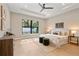 Serene bedroom features tray ceilings, a large window, and modern decor with a view at 1904 Illinois St, Orlando, FL 32803