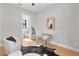 Bright office space featuring a modern clear glass desk and chair, hardwood flooring, and neutral decor at 1904 Illinois St, Orlando, FL 32803