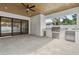 Covered outdoor kitchen with stainless steel appliances, a ceiling fan, and a smooth stone floor at 1904 Illinois St, Orlando, FL 32803
