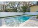 Backyard pool with a white fence and ample room to lounge around at 1904 Illinois St, Orlando, FL 32803