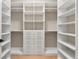 Spacious walk-in closet offers ample storage with custom shelving and drawer units for organization at 1904 Illinois St, Orlando, FL 32803