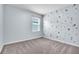 Bedroom with gray carpet and a space-themed wall at 5166 Tana Ter, Saint Cloud, FL 34772