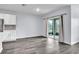 Bright living room with grey wood-look floors and sliding doors to a patio at 5166 Tana Ter, Saint Cloud, FL 34772