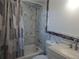 Bathroom featuring a shower-tub combo, marble tiled wall, new toilet, and sink at 16 N Lancelot Ave, Orlando, FL 32835
