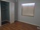 Cozy bedroom featuring hardwood floors, a closet with folding doors, and natural light at 16 N Lancelot Ave, Orlando, FL 32835