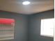 View of a bedroom with blue-grey walls and windows providing natural light at 16 N Lancelot Ave, Orlando, FL 32835