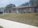 Charming single-story home featuring a well-maintained front yard and an attached garage at 16 N Lancelot Ave, Orlando, FL 32835