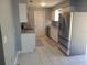 Kitchen with white cabinets, granite countertops, stainless steel appliances, and tile flooring at 16 N Lancelot Ave, Orlando, FL 32835
