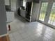 Spacious kitchen featuring white cabinets, stainless steel appliances, and access to the backyard at 16 N Lancelot Ave, Orlando, FL 32835