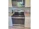 Kitchen with stainless steel oven and microwave, white cabinets, and granite countertops at 16 N Lancelot Ave, Orlando, FL 32835
