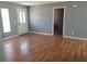 Living room with wood floors and grey walls, view to bedroom at 16 N Lancelot Ave, Orlando, FL 32835