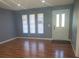 Living room with wood floors, grey walls, and white door at 16 N Lancelot Ave, Orlando, FL 32835