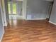Living room with wood floors and grey walls, view to backyard at 16 N Lancelot Ave, Orlando, FL 32835